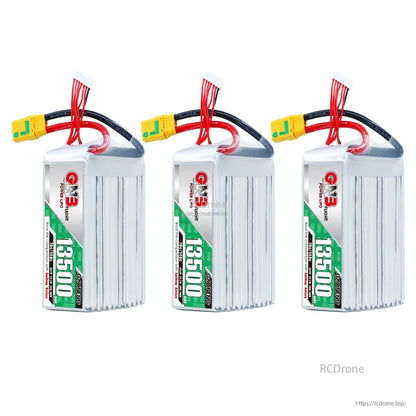 Three-pack lineup of GNB 13500mAh LiPo batteries, upright with XT90S connectors and balance leads