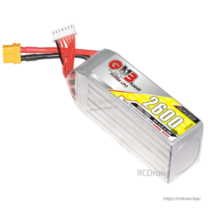 Angled view of GNB 2600 battery showing silver hard case end cap and attached XT60 and balance leads