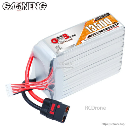 Angled top view of GNB 13500mAh HV LiPo battery showing wires, balance plug, and QS8 connector