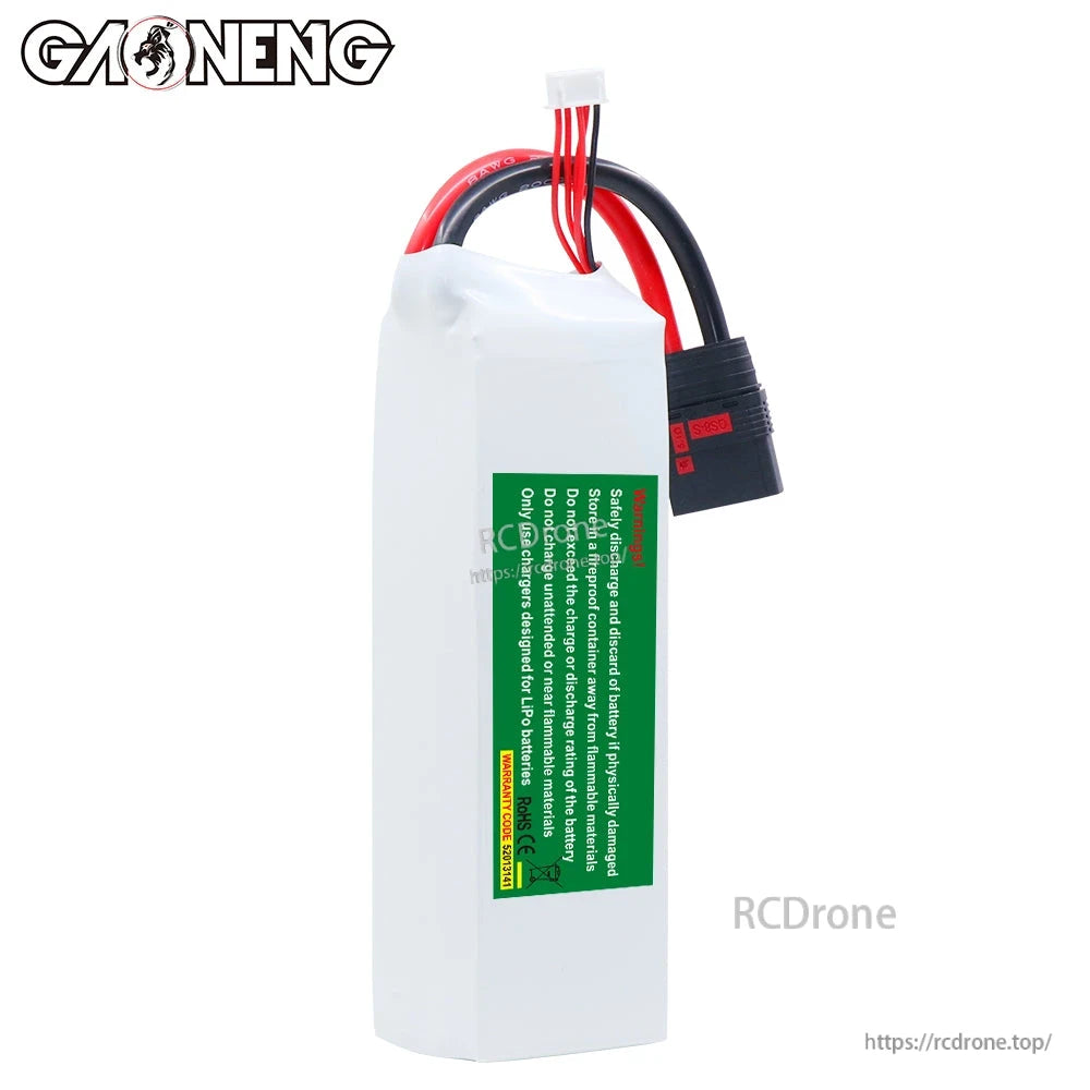 Rear view of battery with green safety warning label and attached power leads