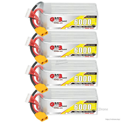 Four GNB 6000mAh LiPo battery packs stacked with discharge leads, balance plugs, and yellow XT90 connectors