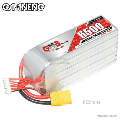 Angled top view of GNB 6500 LiPo pack showing shrink wrap, end cap, XT90 plug, and balance lead