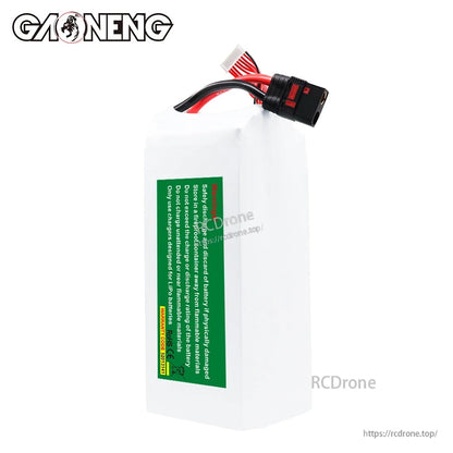 Side view of battery showing green safety warning label and wired leads at top