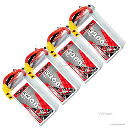 Four GAONENG 5300mAh 70C LiPo batteries arranged diagonally, labels visible with XT90 plugs