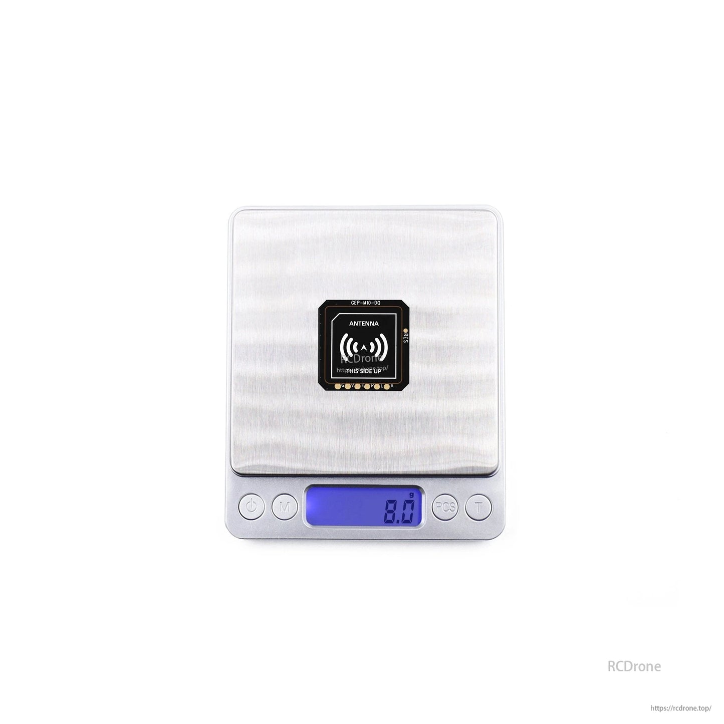 GEPRC GEP-M10 series GPS module on a digital scale showing 8.0g, with antenna side marked “this side up”