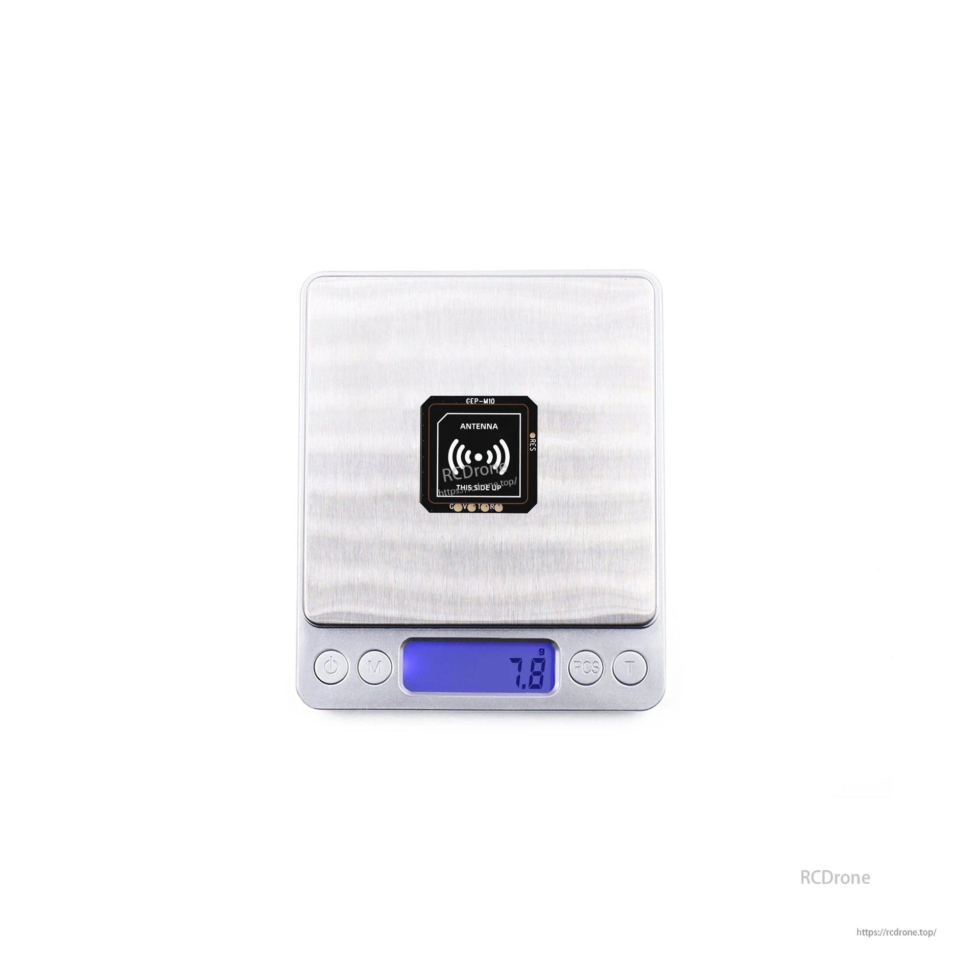 GEPRC GEP-M10 Series GPS, GEPRC GEP-M10 GPS module on a digital scale reading 7.8 g, with “ANTENNA” and “this side up” label