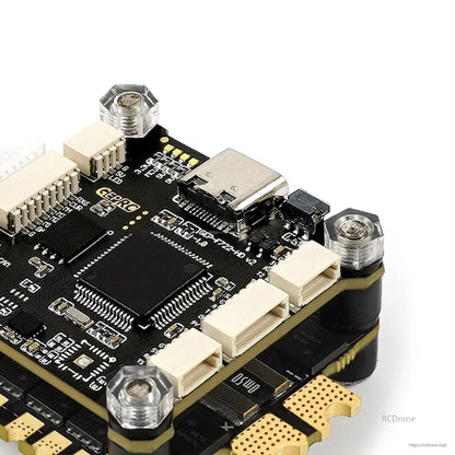 Close-up of GEPRC TAKER F722 flight controller stack with USB-C port, plug connectors, and metal standoffs