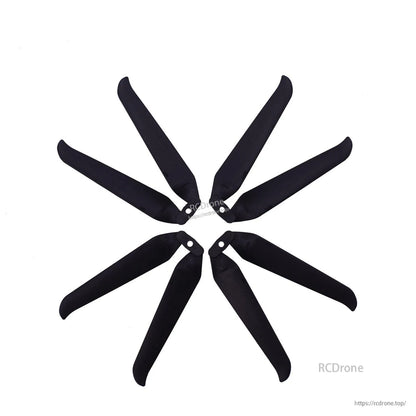 Multiple black folding propeller blades arranged in a circle to show blade shape and hub holes