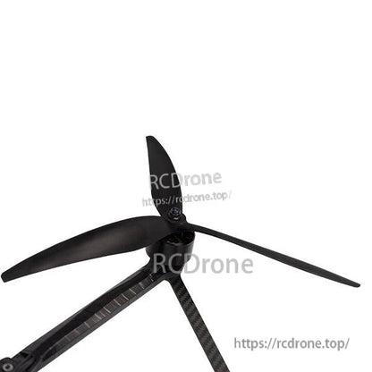 3-blade propeller mounted on drone motor arm, angled view showing blade clearance and hub fit