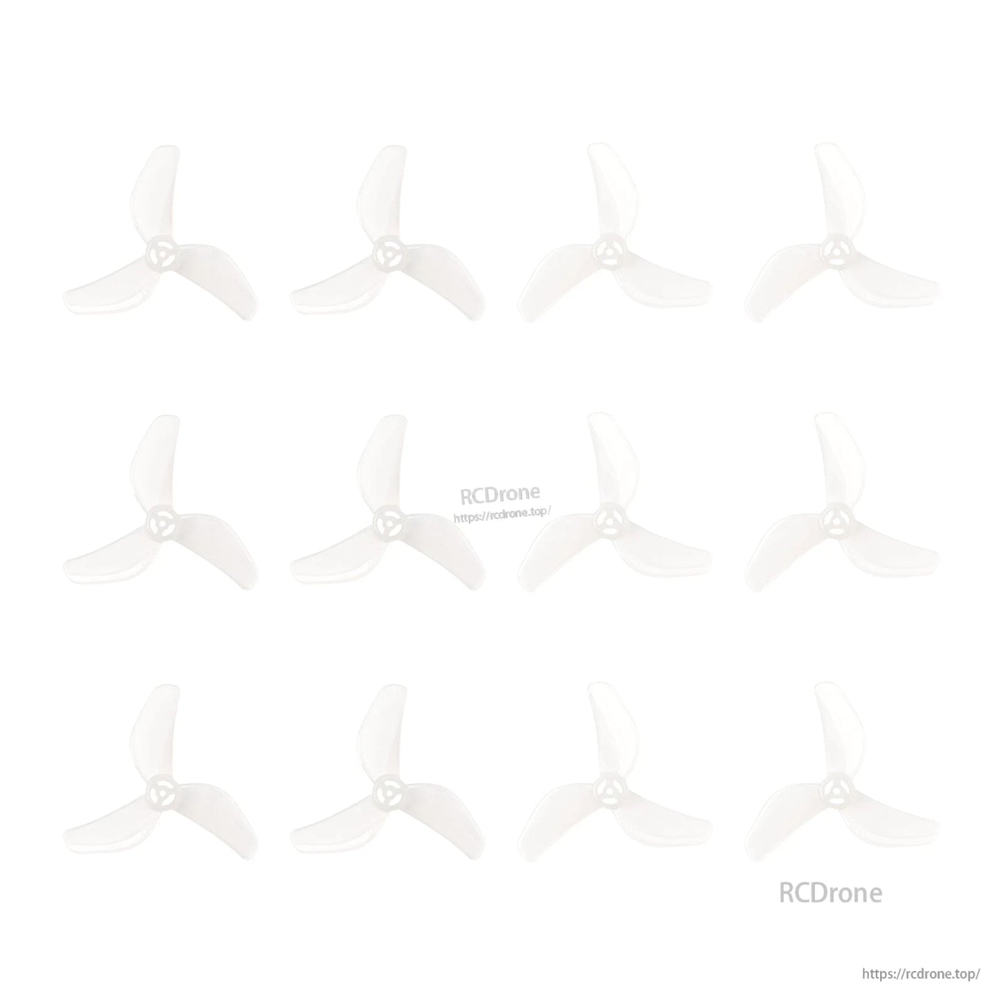 Multiple clear 3-blade micro drone propellers laid out in a grid, showing several identical props