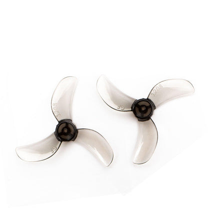 Translucent smoke gray 31mm tri-blade propellers with black hubs, clockwise and counterclockwise pair