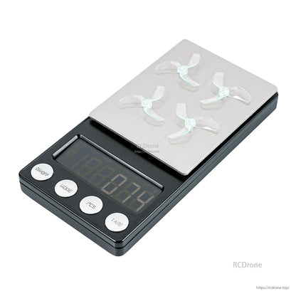 Gemfan 1219S 3-Blade Propeller set placed on a digital scale platform for weight reference