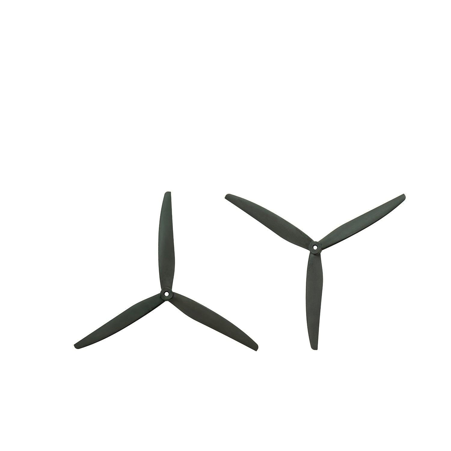 Two black three-blade drone propellers shown as a pair, top and bottom views on white background