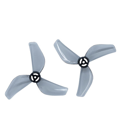 Two clear gray tri-blade micro drone propellers with black hubs, top view