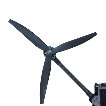 15-inch tri-blade drone propeller mounted on motor and carbon fiber arm, angled view