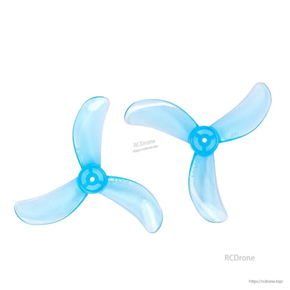 Two clear blue tri-blade props shown at an angle, hub bore and blade sweep visible