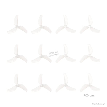 Multiple clear 3-blade propellers laid out in rows on white background, showing batch quantity