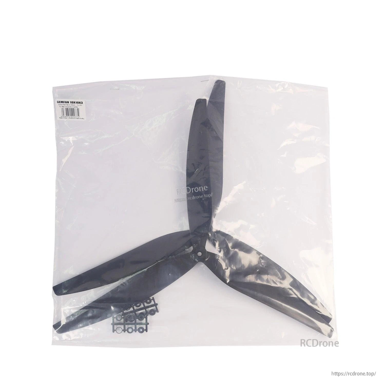 Package contents laid out: propeller in clear bag with adapter ring sprue visible at bottom left