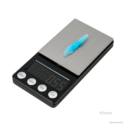 Single translucent blue 2-blade propeller shown on a digital pocket scale for weight reference