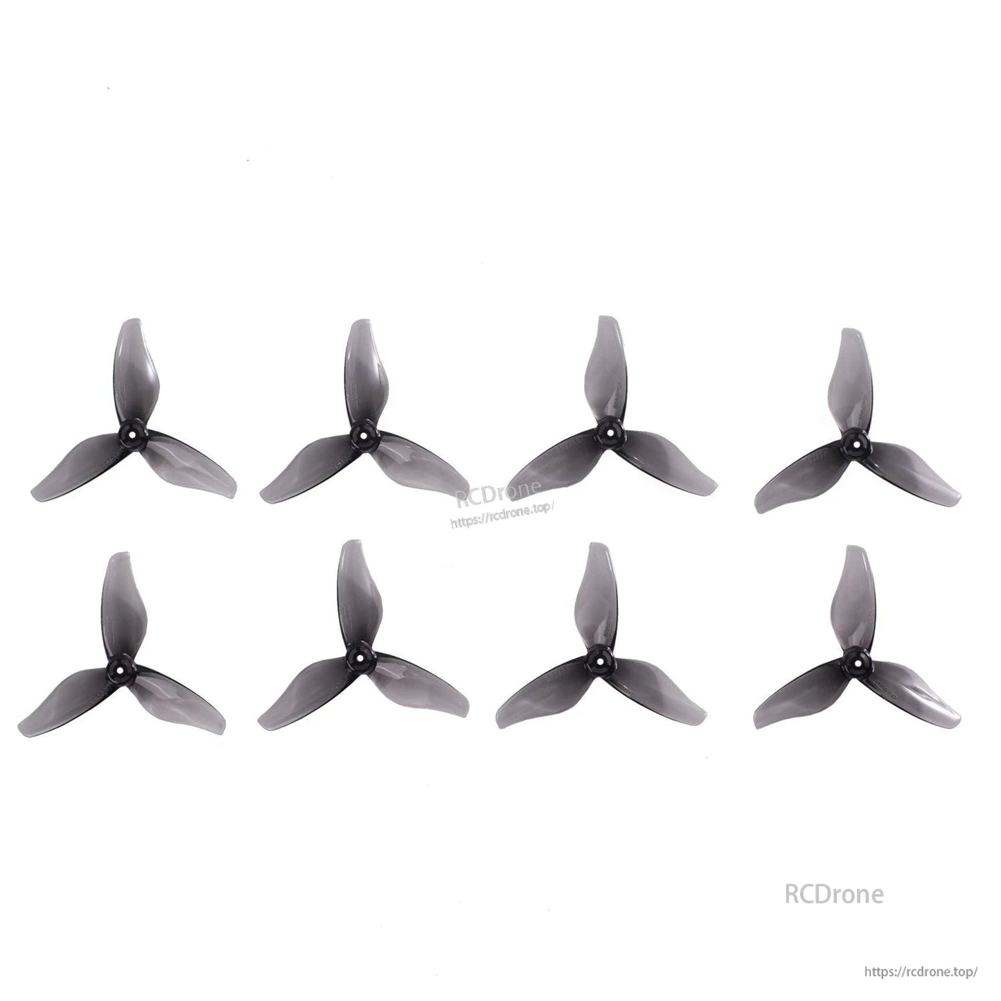 Eight translucent smoke gray 3-blade 2-inch drone propellers displayed in rows on white