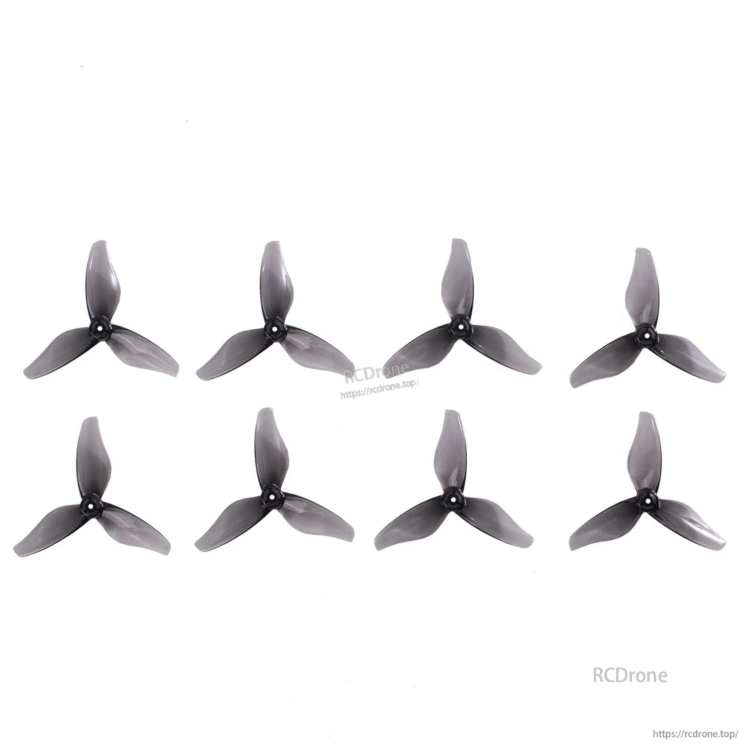 Eight translucent smoke gray 3-blade 2-inch drone propellers displayed in rows on white