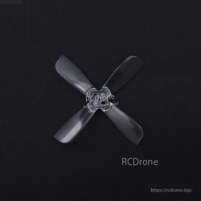 Black 4-blade propeller angled view showing blade profile and hub detail