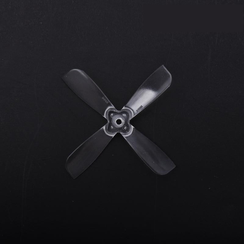 Black 4-blade propeller with 3-hole/square mounting hub, close-up on dark background