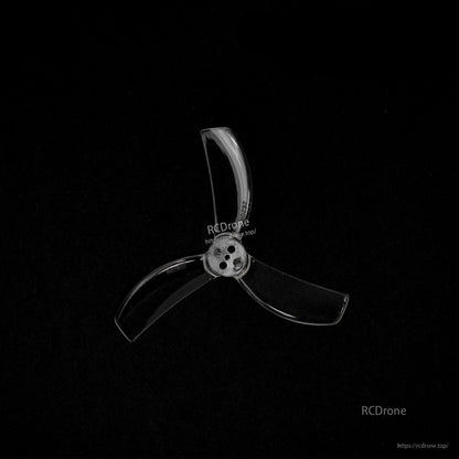 Single transparent 3-blade propeller on black background, close-up of center hub and holes