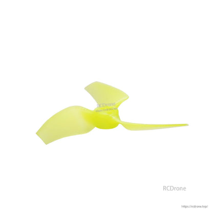 Neon yellow tri-blade propeller side profile, low-angle view showing curved blades