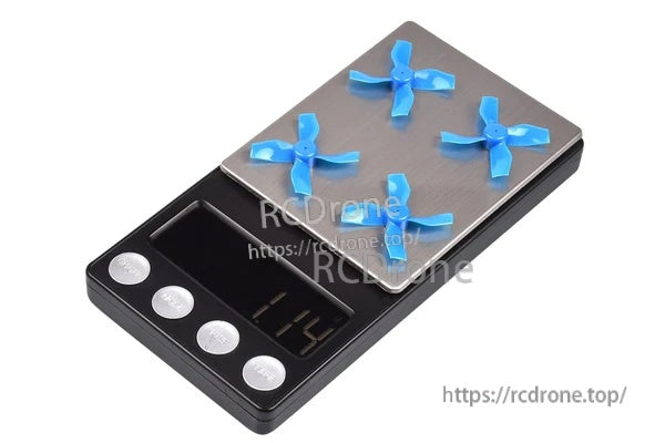 Digital scale showing four blue 31mm 4-blade micro whoop props, lightweight PC propellers