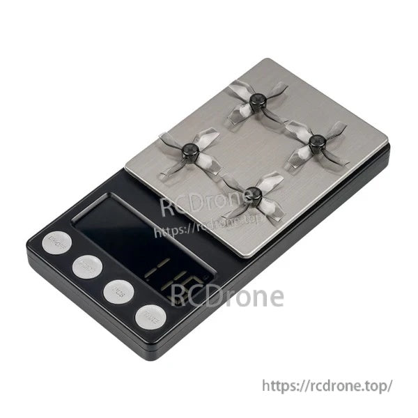 Digital scale with four grey 31mm 4-blade micro whoop propellers, weight display close-up