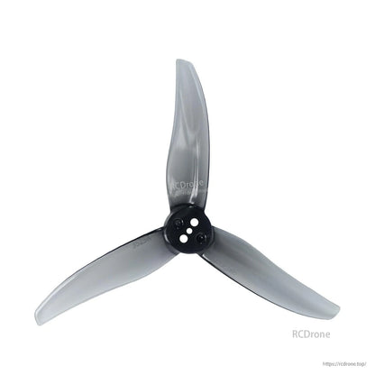 Clear gray 3-blade propeller close-up showing hub and blade shape, three-hole mount