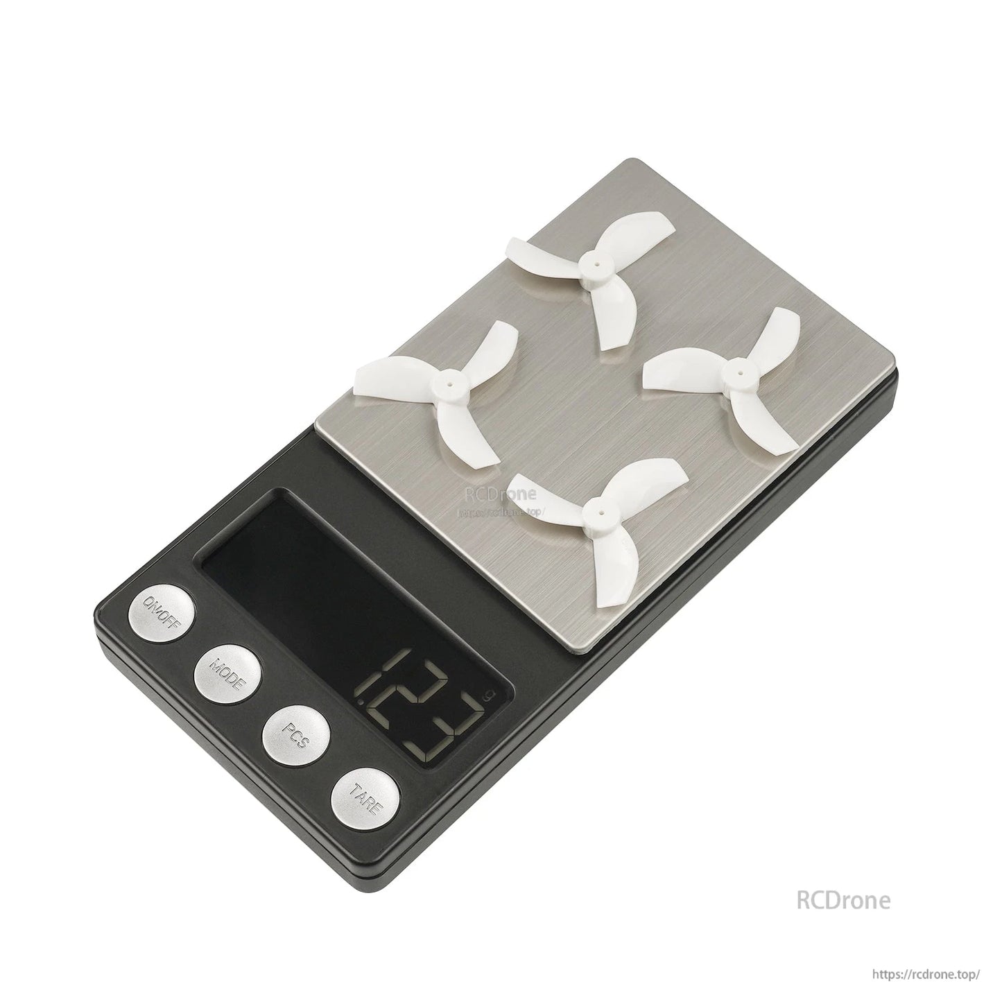 Four clear 35mm 3-blade whoop props on digital scale, weight display 2.3 g