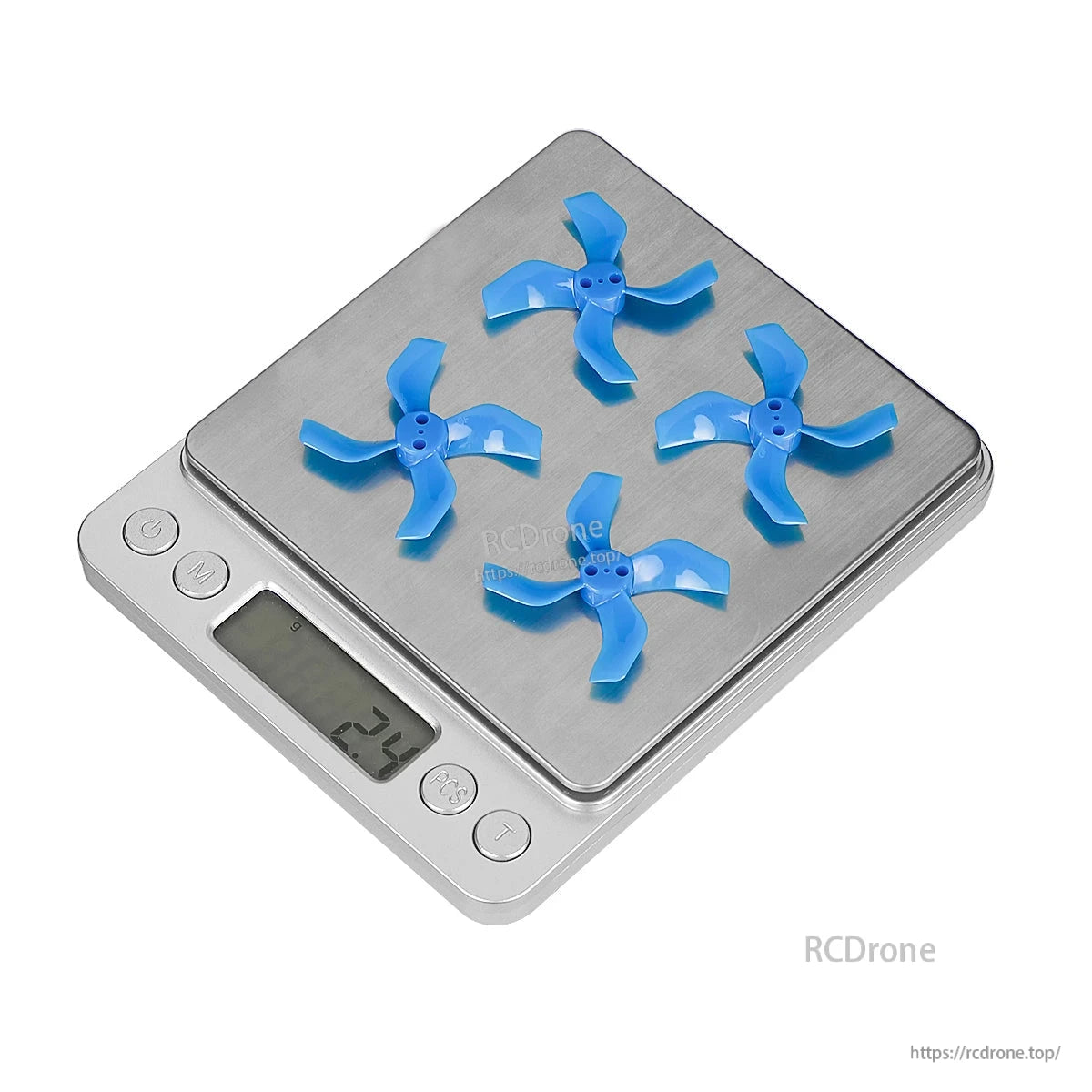 Four blue 4-blade micro drone propellers on a digital scale, display reading 2.3