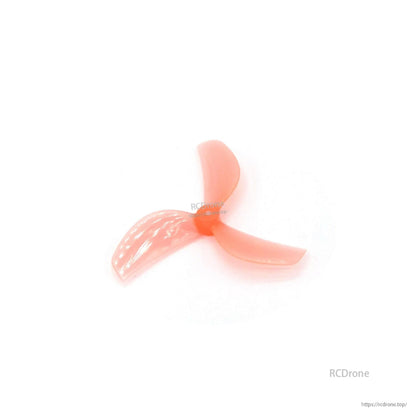 Translucent red 3-blade propeller, lighter shade angled view showing molded blade texture