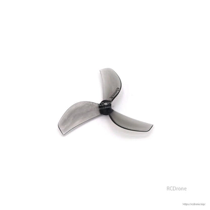 Clear gray 3-blade propeller, angled view with Gemfan marking visible on blade