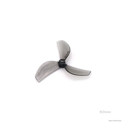 Smoky clear gray 3-blade propeller, angled view showing blade profile and pitch