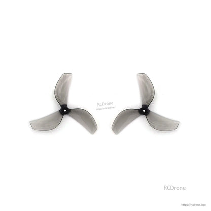 Two clear gray 3-blade propellers side by side, black hubs aligned