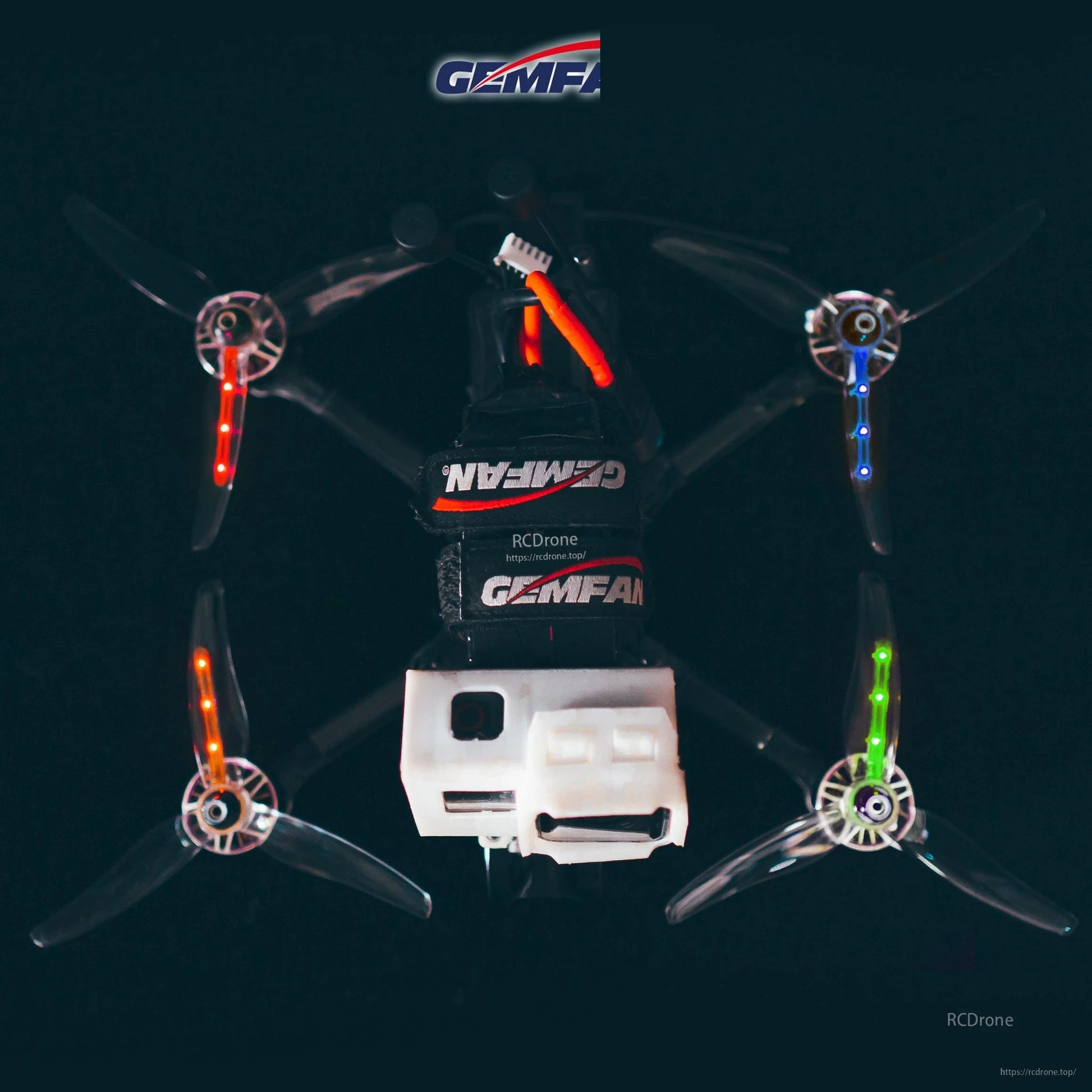 Top view of quadcopter with transparent 3-blade props and red, blue, and green LED light strips