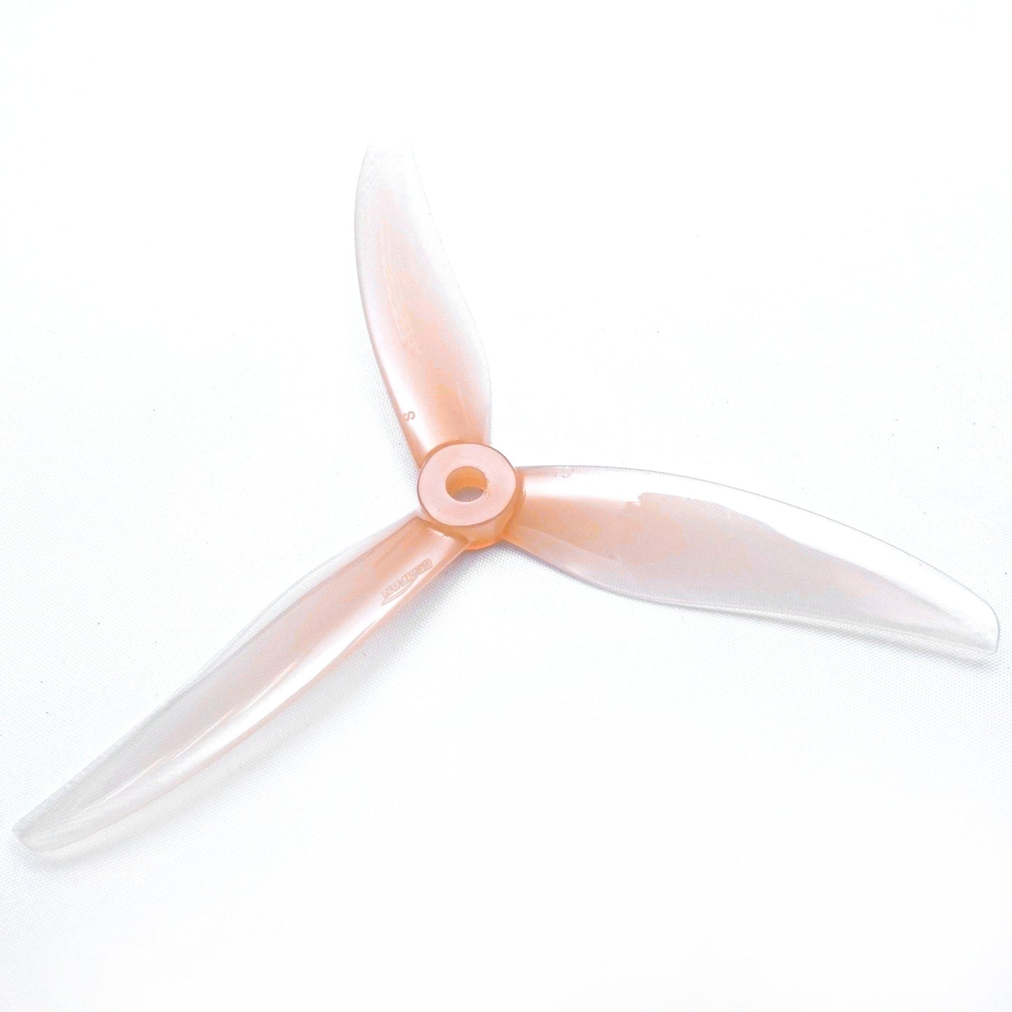 Clear light pink 3-blade FPV propeller, top view showing translucent blades and hub detail