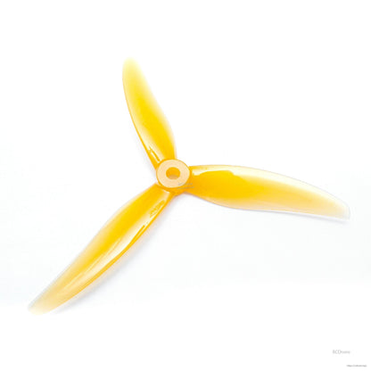 Yellow 3-blade FPV drone propeller, top view with glossy blades and round center hub