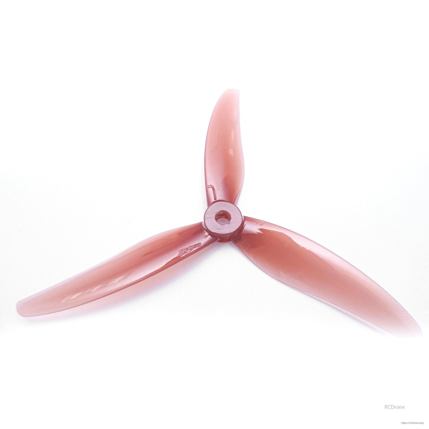 Transparent red 3-blade FPV drone propeller, top view showing curved blades and center hub