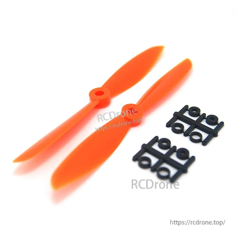 Single orange Gemfan 6045 prop with two adapter ring sprues shown separately on white background