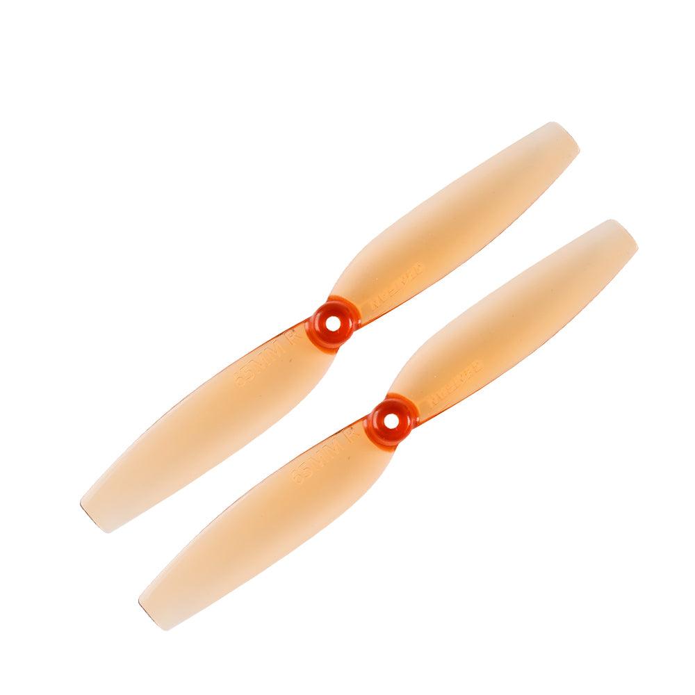 Two-blade micro quad propellers in translucent orange with red hubs, top view