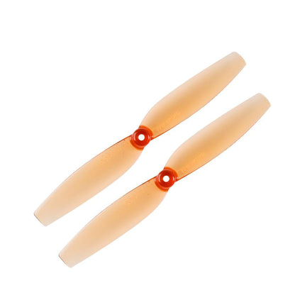 Two-blade micro quad propellers in translucent orange with red hubs, top view