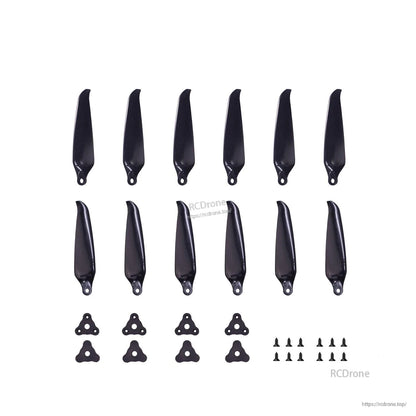 Propeller set contents laid out: black folding blades, hub plates and mounting screws