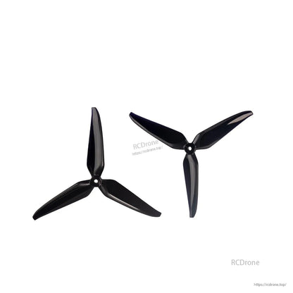 Two black 3-blade propellers on white background with RCDrone watermark, top view comparison