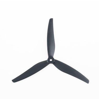 Black tri-blade propeller close-up showing hub and three blades on white background