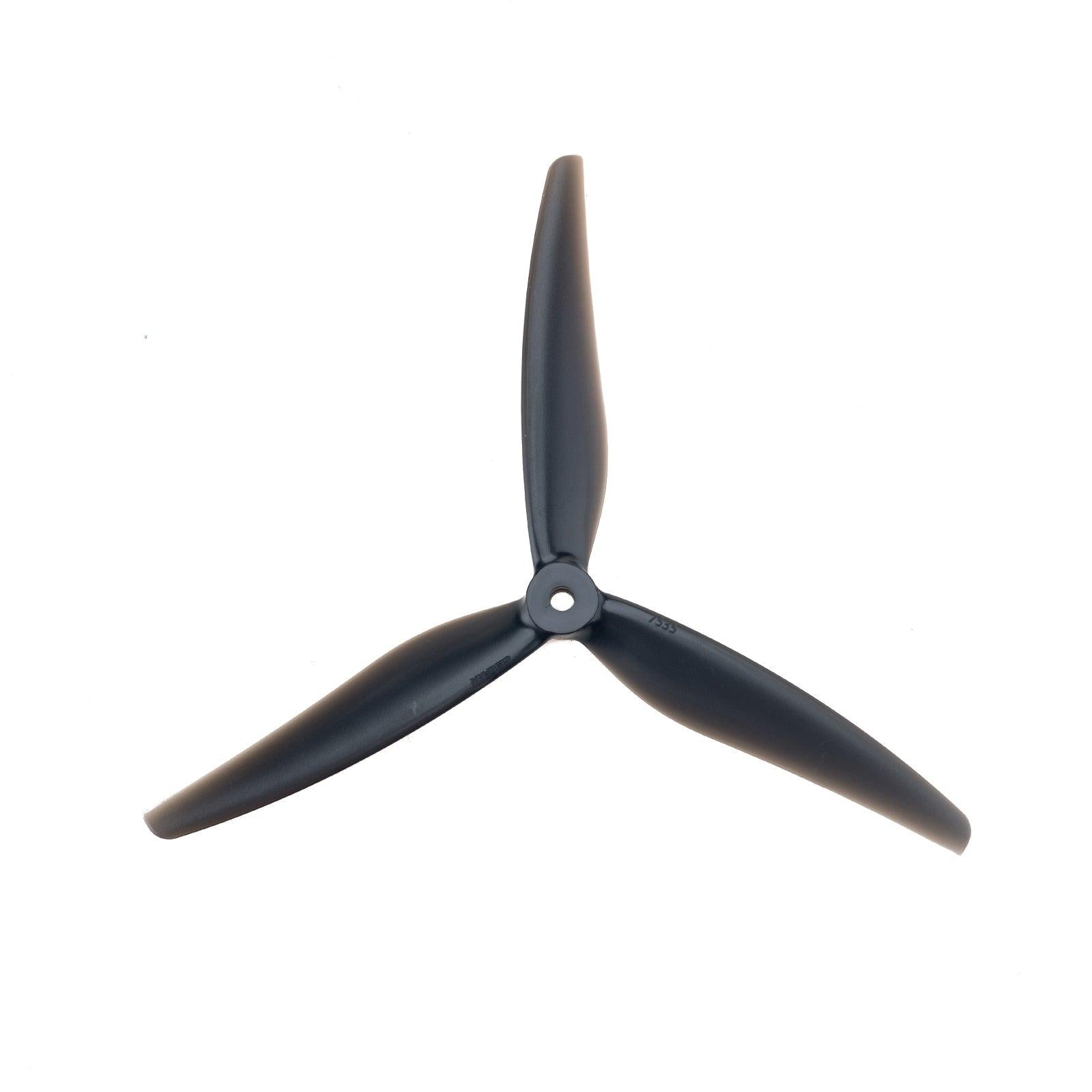 Black 3-blade drone propeller, rear side view showing hub and blade curvature