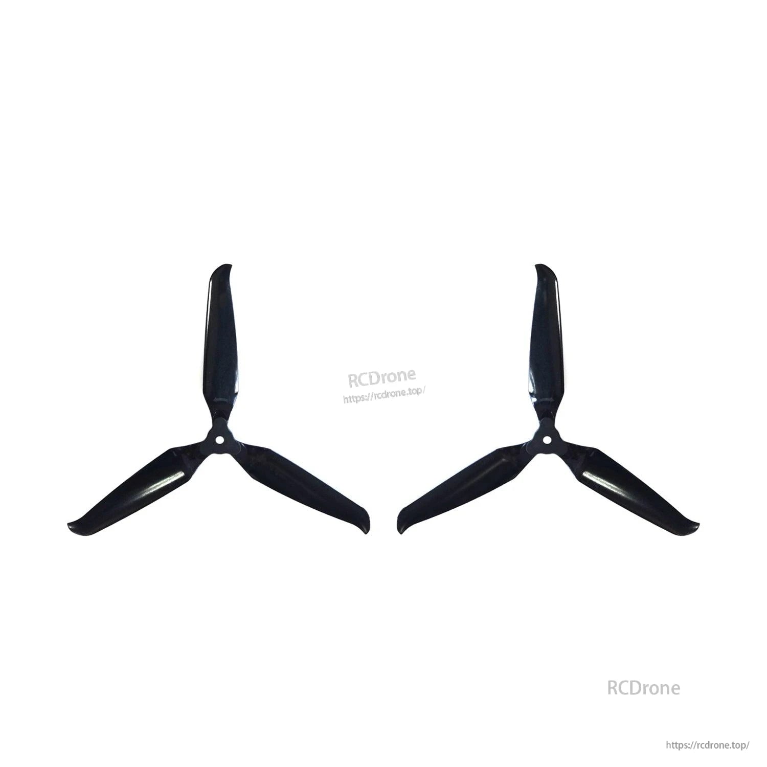 Two assembled 3-blade propellers spaced apart on white background, black finish